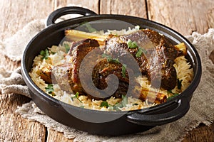 LambÂ haneethÂ is a traditional dish with basmati rice close-up in a frying pan. horizontal